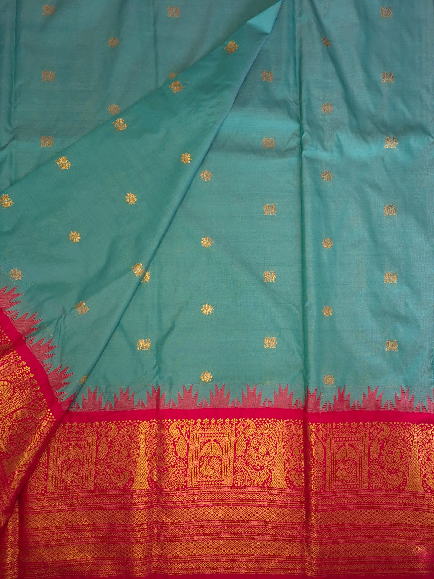 Turquoise Blue Gadwal Silk Saree with all-over Golden Buttas and Intricate Design on Red Border