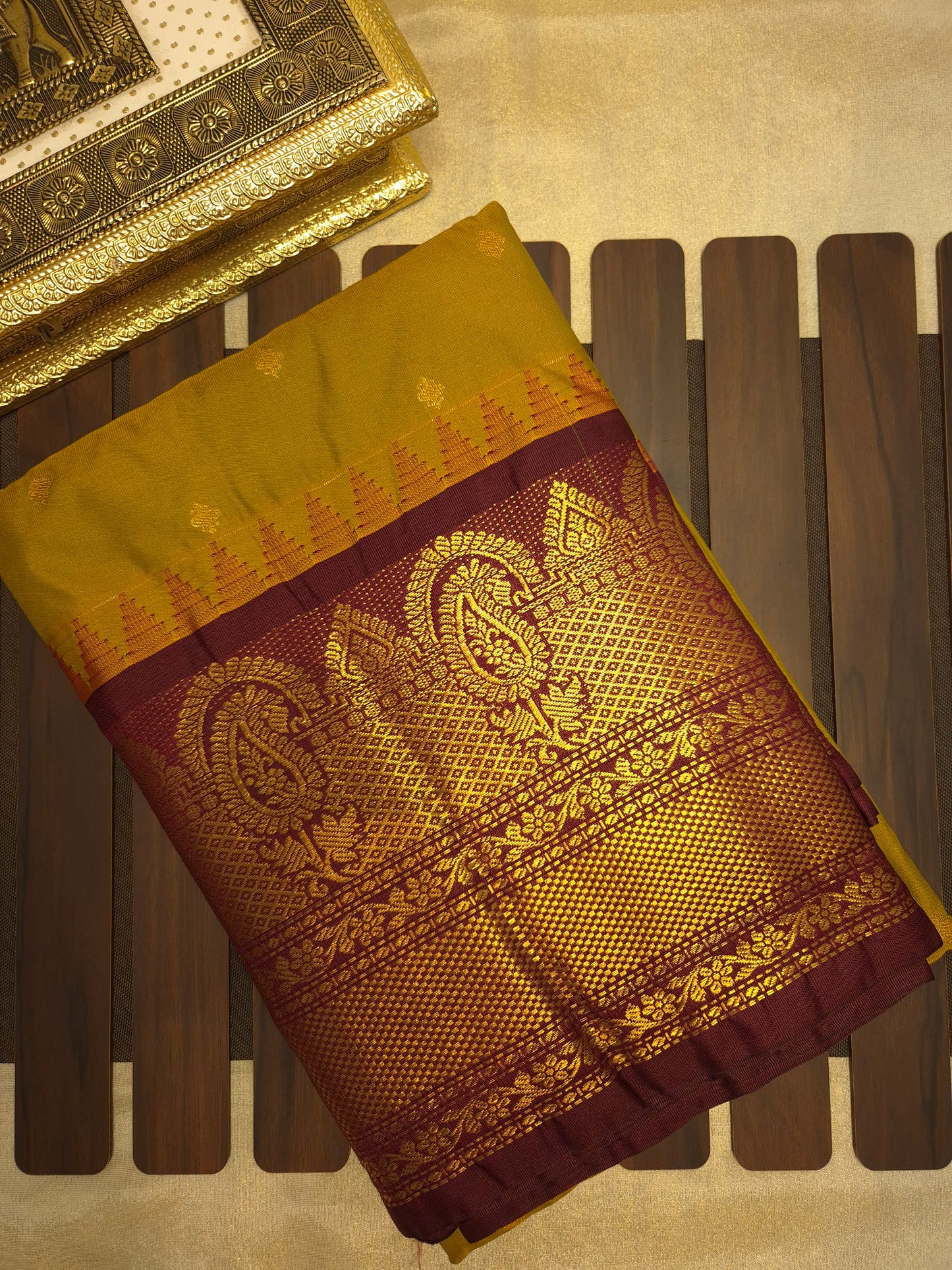 Brass Yellow Gadwal Silk Saree with all-over Golden Buttas and Intricate Design on Wine Colour Border