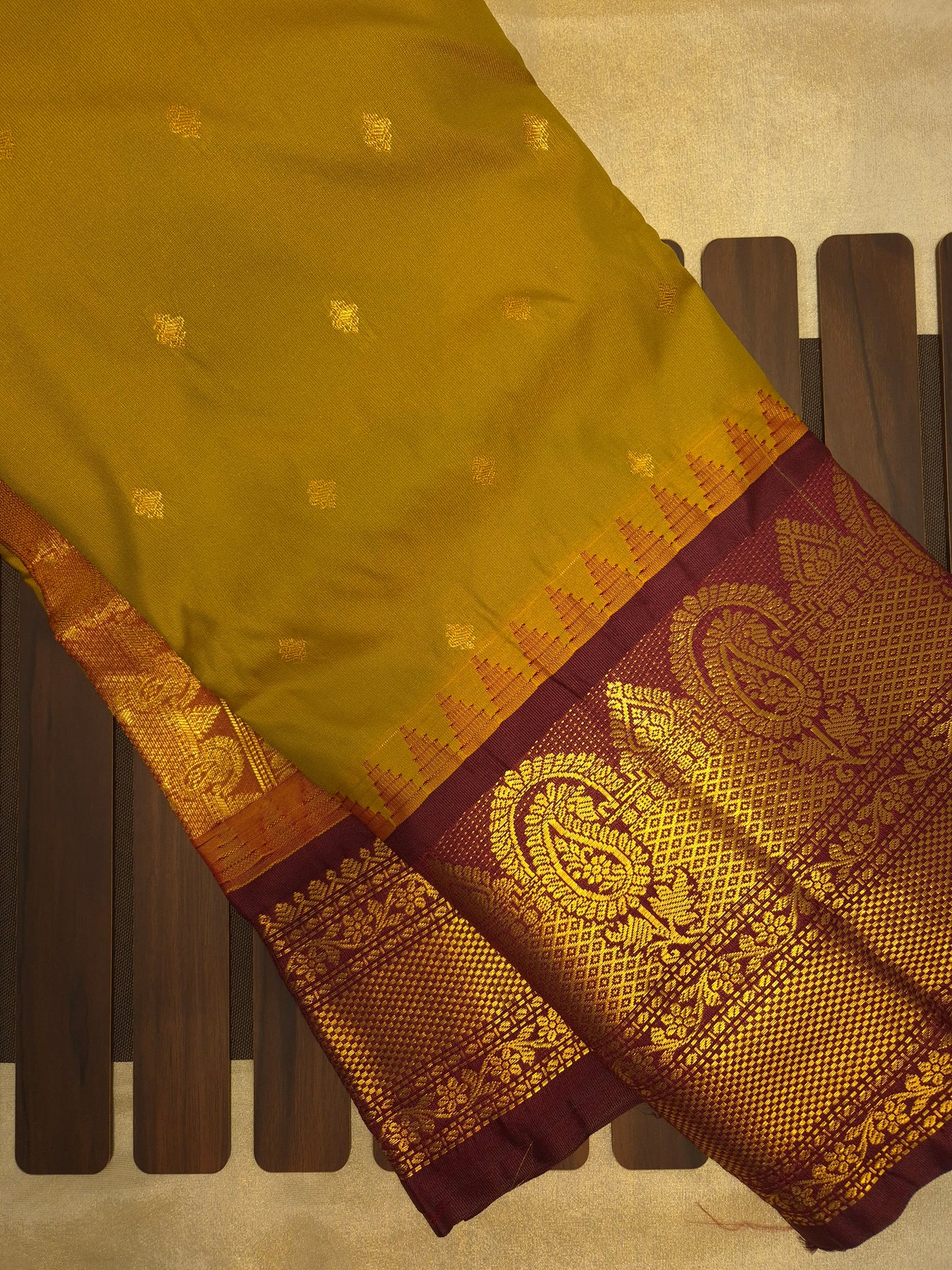 Brass Yellow Gadwal Silk Saree with all-over Golden Buttas and Intricate Design on Wine Colour Border