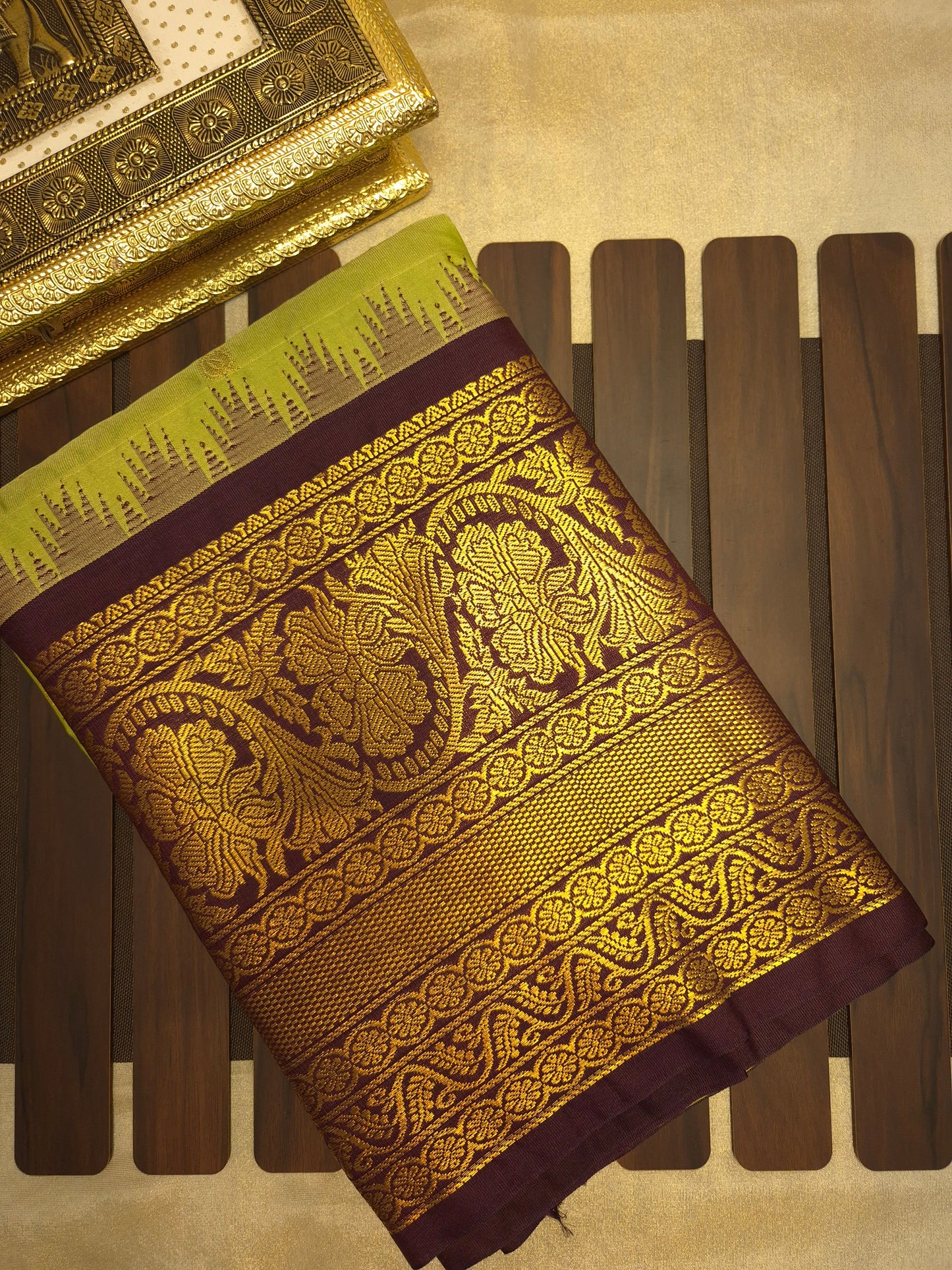 Light Green Gadwal Silk Saree with all-over Golden Buttas and Intricate Design on Wine Colour Border