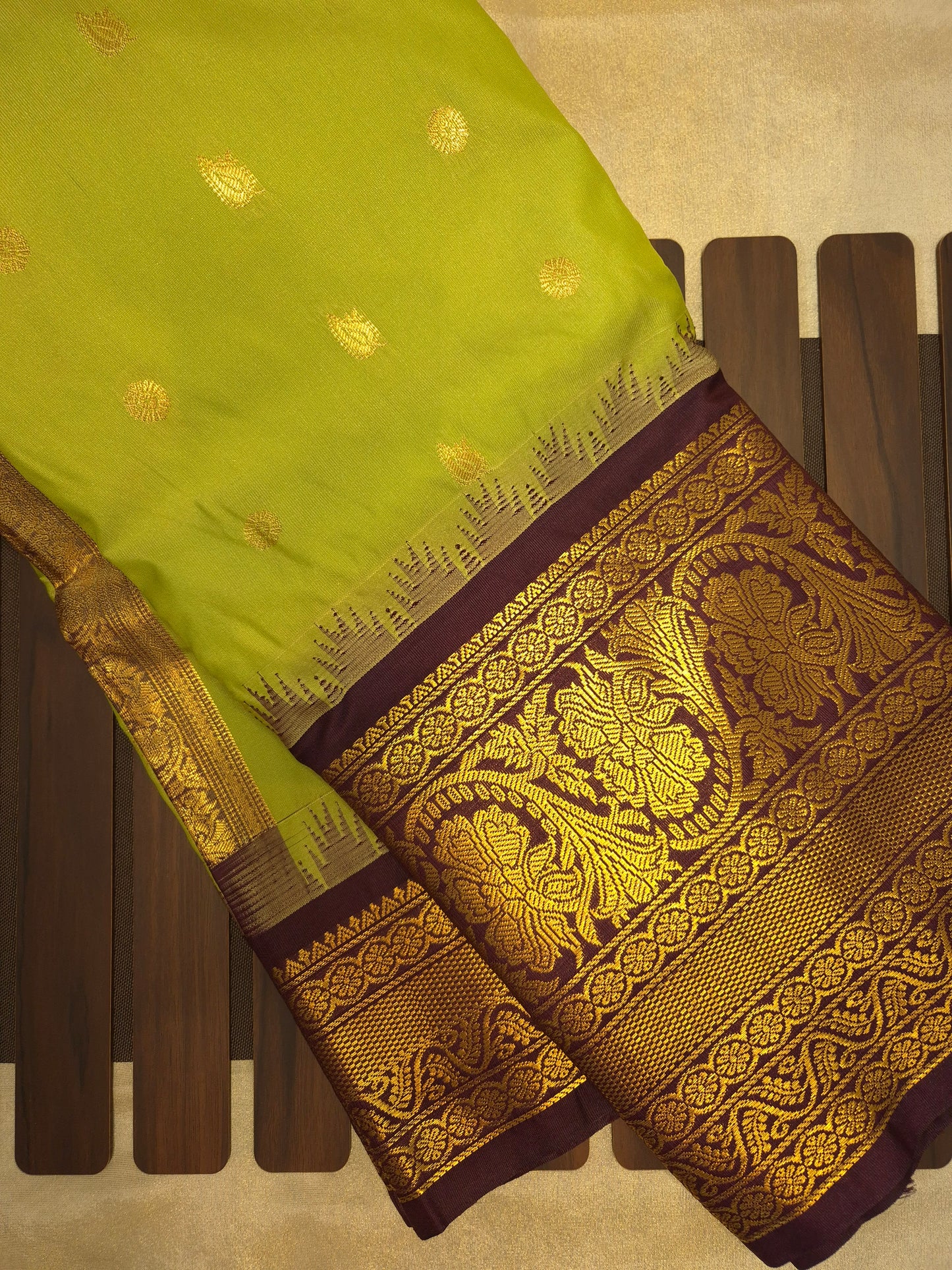Light Green Gadwal Silk Saree with all-over Golden Buttas and Intricate Design on Wine Colour Border