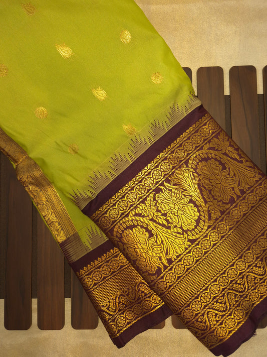 Light Green Gadwal Silk Saree with all-over Golden Buttas and Intricate Design on Wine Colour Border