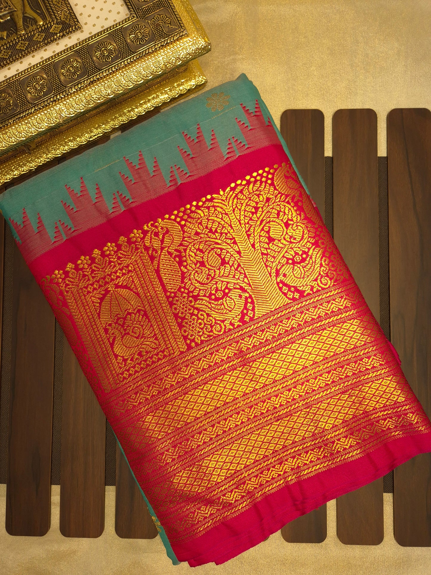 Turquoise Blue Gadwal Silk Saree with all-over Golden Buttas and Intricate Design on Red Border