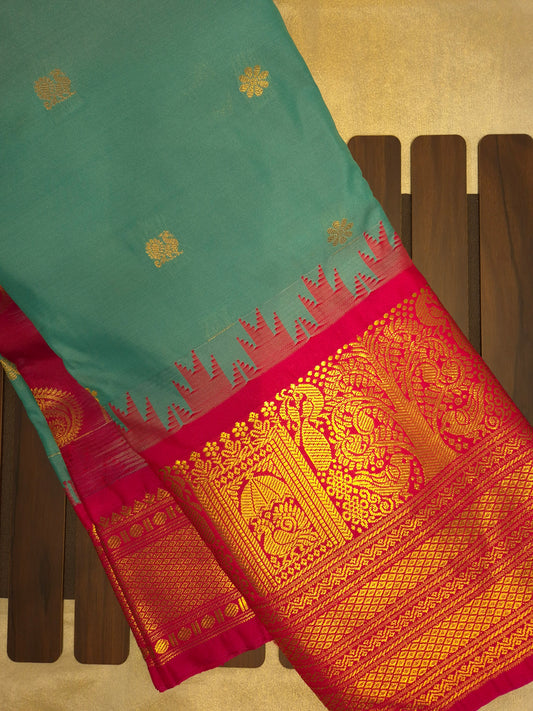 Turquoise Blue Gadwal Silk Saree with all-over Golden Buttas and Intricate Design on Red Border