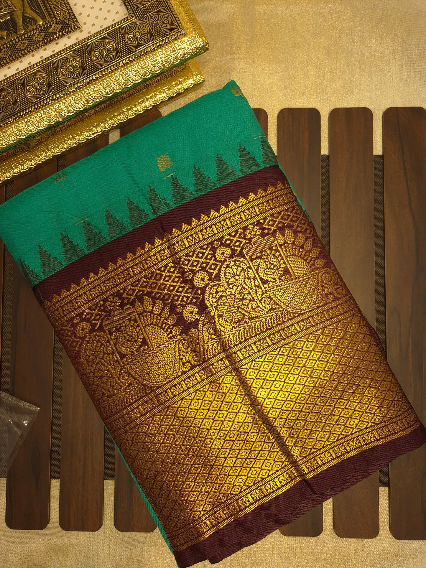 Peacock Green Gadwal Silk Saree with all-over Golden Buttas and Intricate Design on Wine Colour Border