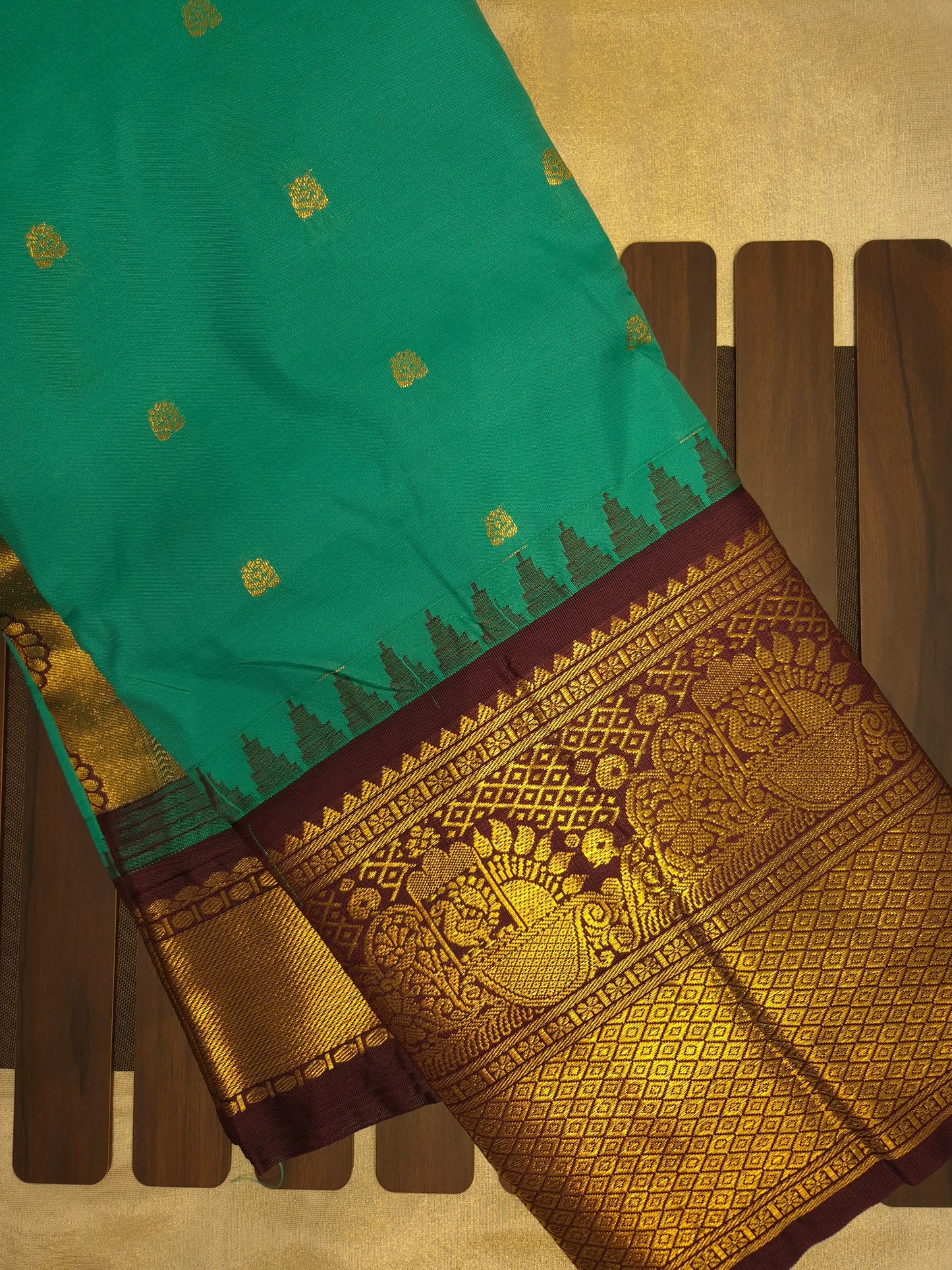 Peacock Green Gadwal Silk Saree with all-over Golden Buttas and Intricate Design on Wine Colour Border