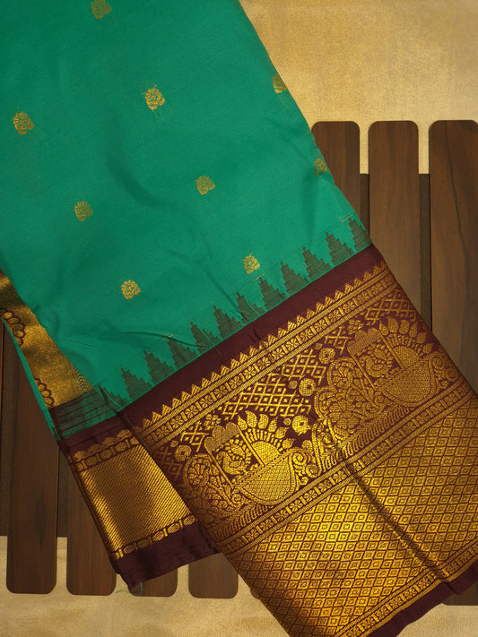 Peacock Green Gadwal Silk Saree with all-over Golden Buttas and Intricate Design on Wine Colour Border