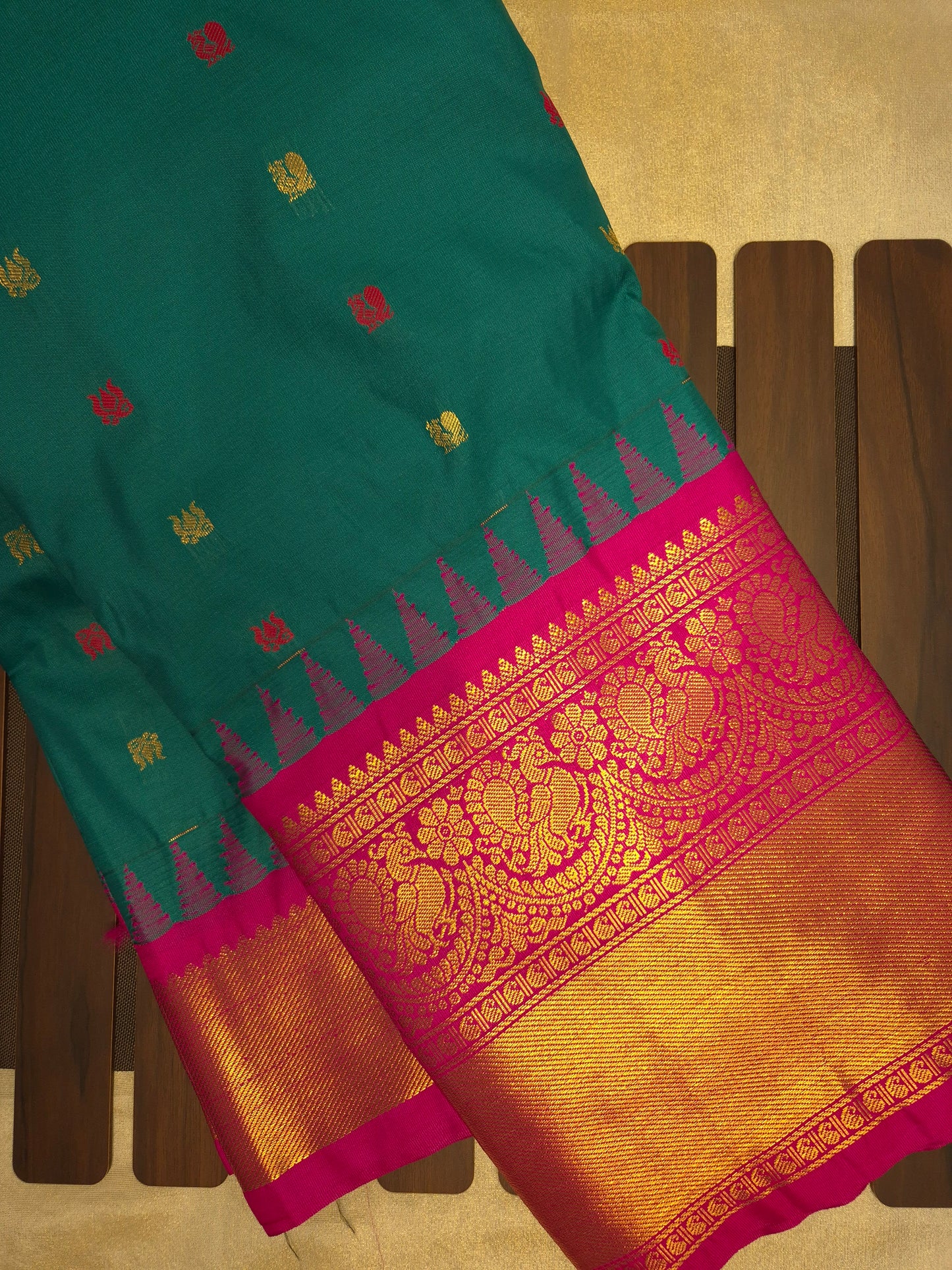 Deep Sea Green Gadwal Silk Saree with all-over Golden Buttas and Intricate Design on Rani Pink Colour Border