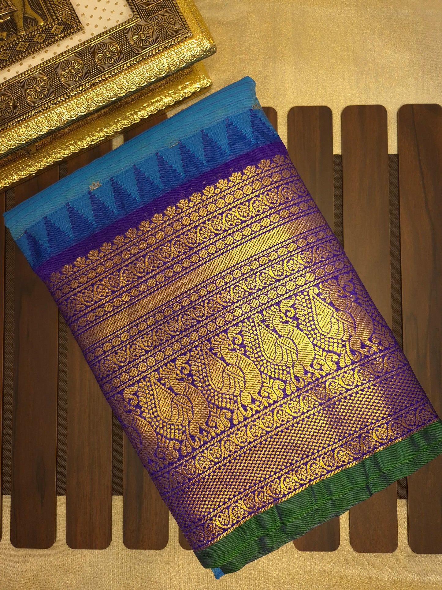 Blue Gadwal Silk Saree with all-over Golden Buttas and Intricate Design on Violet Border