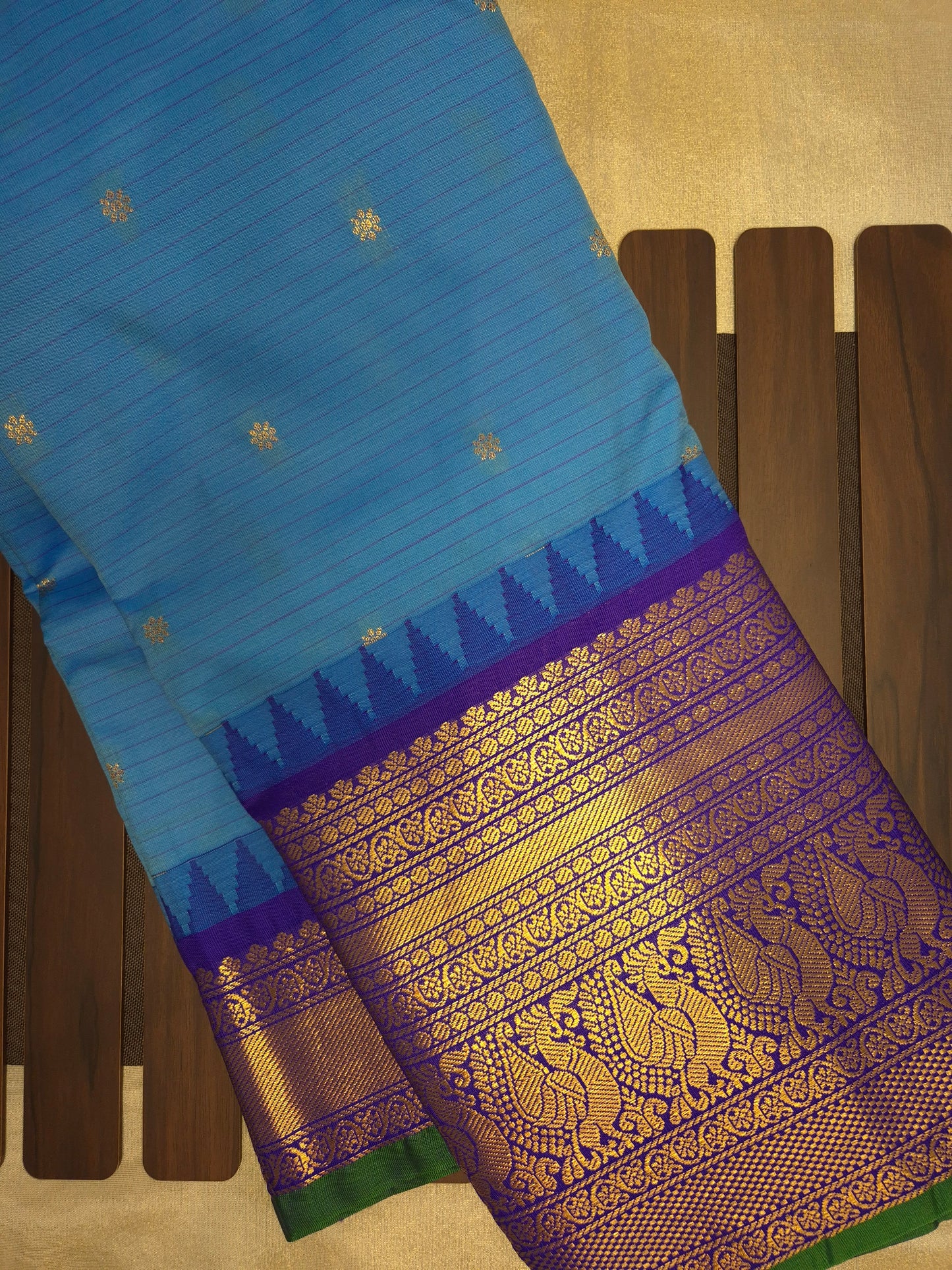 Blue Gadwal Silk Saree with all-over Golden Buttas and Intricate Design on Violet Border