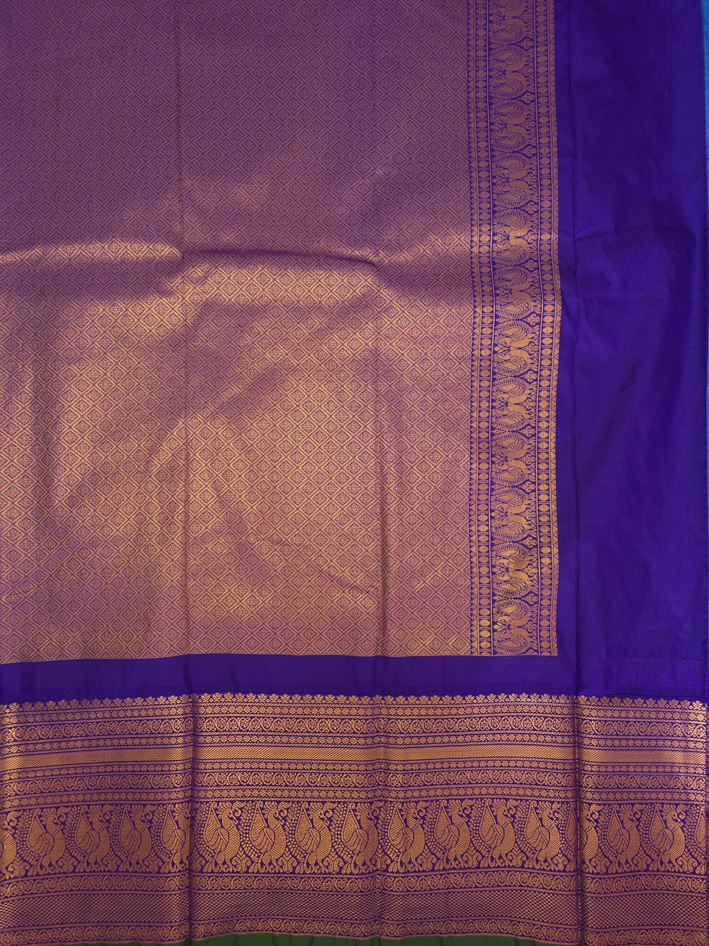 Blue Gadwal Silk Saree with all-over Golden Buttas and Intricate Design on Violet Border