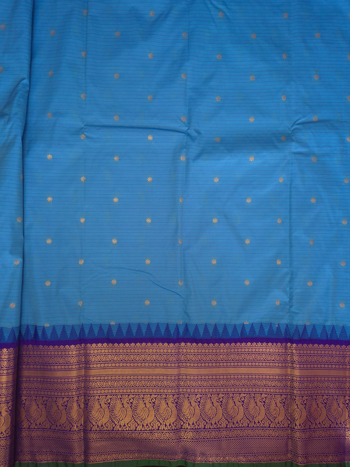 Blue Gadwal Silk Saree with all-over Golden Buttas and Intricate Design on Violet Border