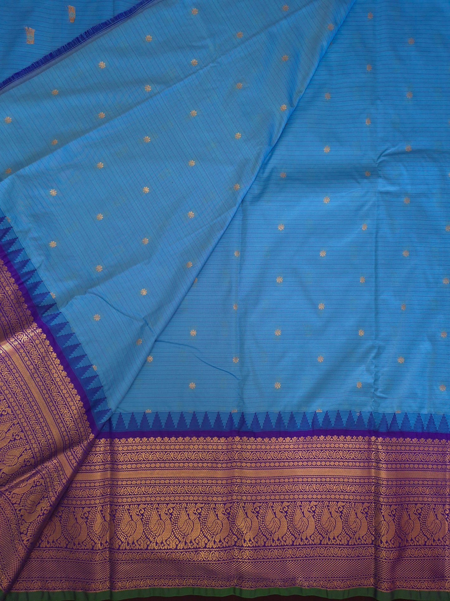 Blue Gadwal Silk Saree with all-over Golden Buttas and Intricate Design on Violet Border