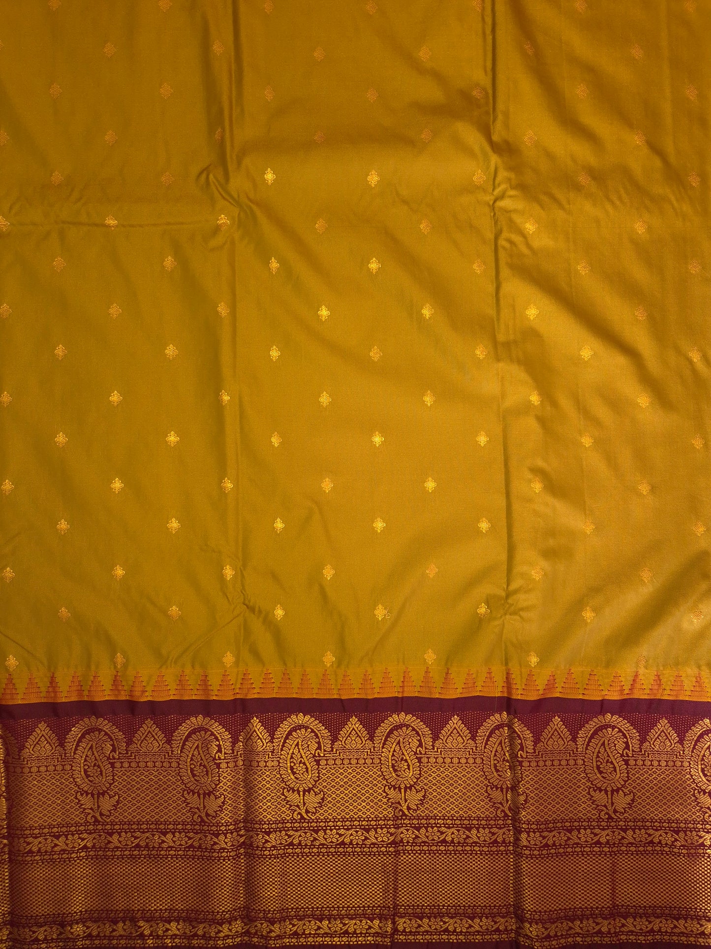 Brass Yellow Gadwal Silk Saree with all-over Golden Buttas and Intricate Design on Wine Colour Border